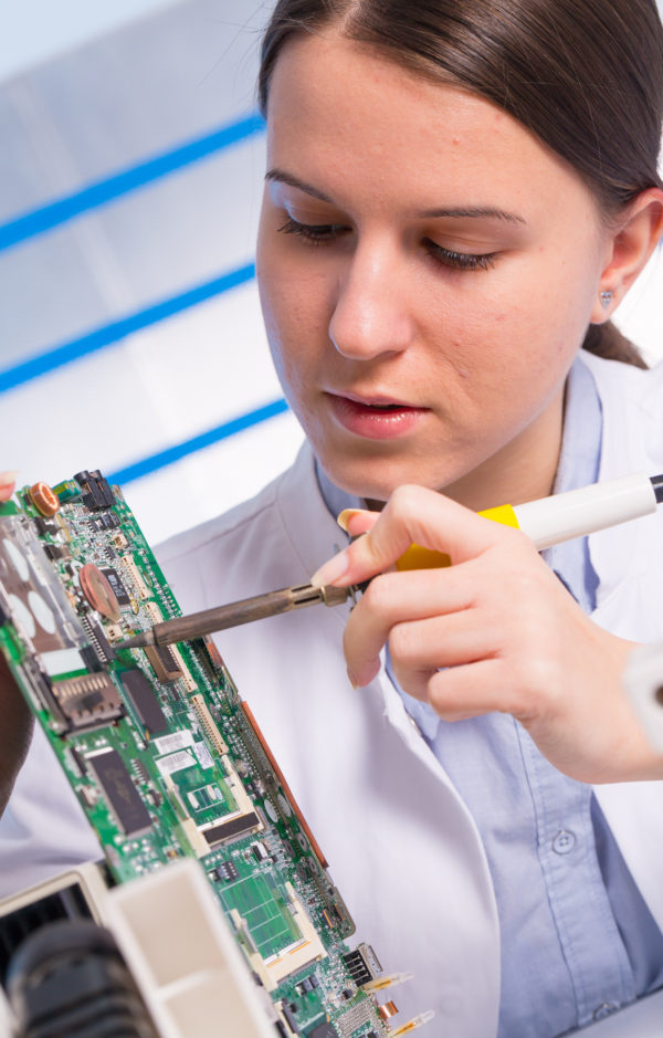 Young woman technician repair electronics device