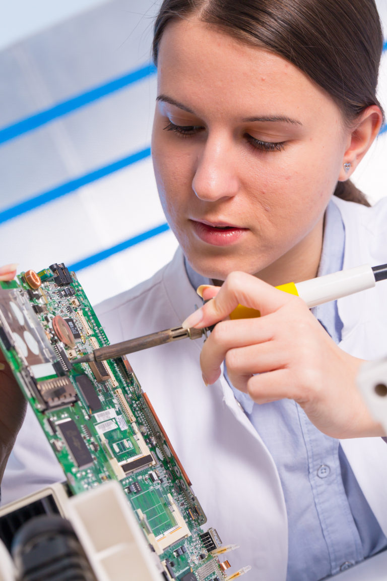 Young woman technician repair electronics device - AMAC Technologies